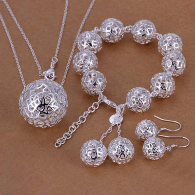 silver-plated ball pendant jewelry set featuring a necklace, bracelet, and earrings on a brown background.